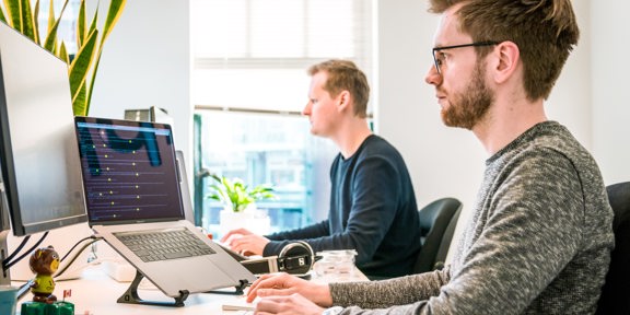 2 Men Working At Computers